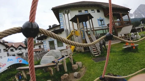 POV inside net spinning ride in a kid playground. Dolomites, Trentino, Italy. Stock Footage 119874841