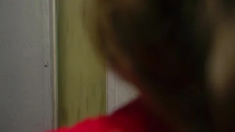 POV inside old elevator ascending with blurred female in red in foreground Stock Footage 290771341