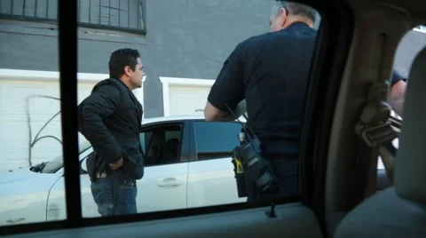 POV from inside Police Patrol Car of Policeman talking with a man in a sport coa Stock Footage 59166080