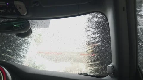 Pov from inside a vehicle driving through an automatic car wash tunnel, showing Stock Footage 340230703