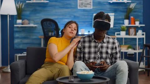 POV of interracial couple using technology for entertainment 写真素材