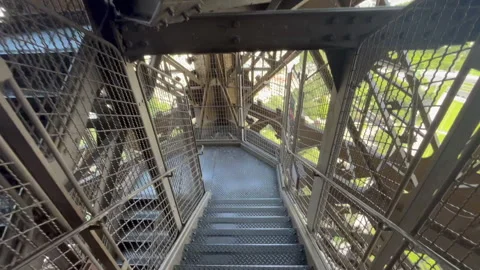 POV Journey Down Eiffel Tower's Stairs Wide-Angle Without Crowds 1080p Stock Footage 252882474