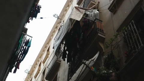 POV look Up at laundry hangs on balconies in a narrow stony passage, alley Video stock 201749334