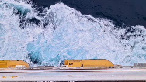 POV looking down at deep blue ocean and white waves from cruise ship balcony Stock Footage 345177275