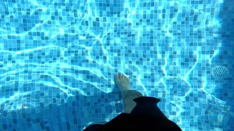 Pov looking at the feet inside the pool with water in point of view in 4k in the Stock Footage 199553284
