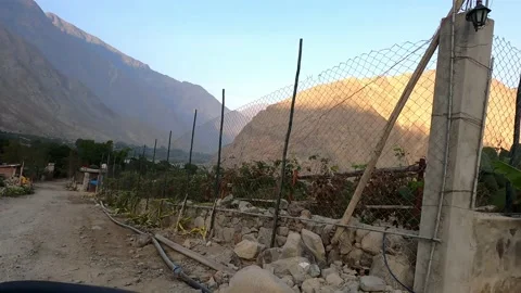 Pov looking out of car window country houses with mountains background in highla Stock Footage 199555966