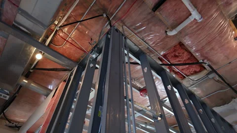 POV of Low-angle view of an unfinished interior ceiling with HVAC duct Vidéo 326182289