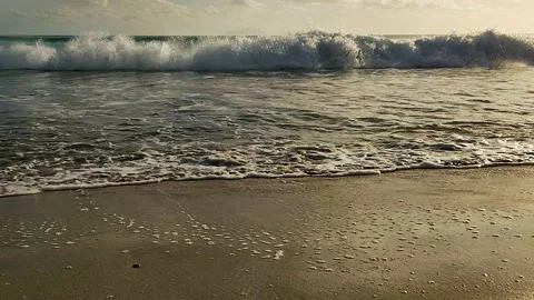 POV-Low Angle-Walking beach as breaking waves crash and wash ashore Stock Footage 229911596