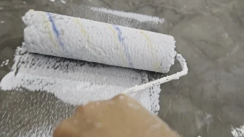 POV Macro Close Up of Paint Roller Coating Smooth Concrete Wall White Stock Footage 342930093