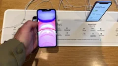POV male hand holding in Apple Store new iPhone Leather wallet