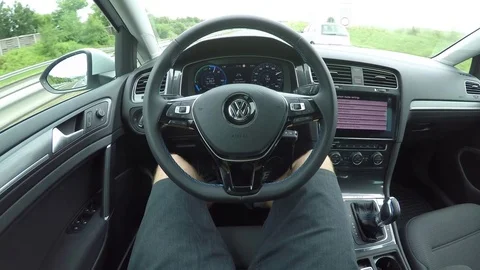 POV: Man in autonomous self-driving electric car on highway using autopilot mode Stock Footage