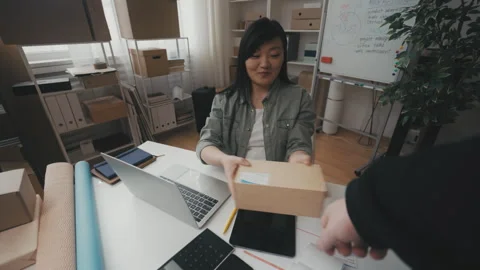 Pov of a man bringing a parcel for shipping at post office, worker accepting box Stock Footage 251733744