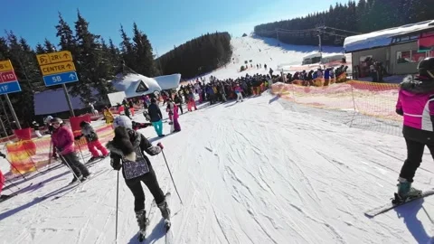POV. Man With Camera On His Head skiing down to the chairlift queue Stock Footage 219256475