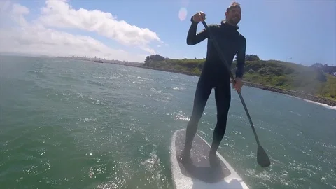 POV of a man crashing wipeout sup stand-up paddleboard surfing under the Golden Stock Footage