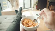 Pov Of A Man Eating Cereal On A Couch Stock Footage