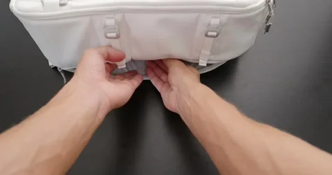 POV. Man hand pulls a silver laptop from white stylish backpack. Stock Footage 259089030