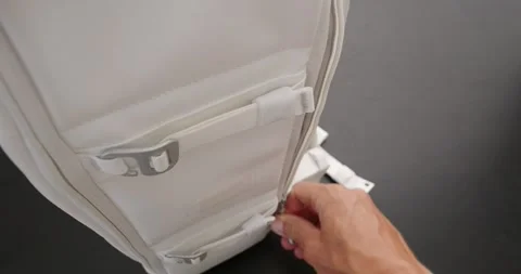 POV. Man hand pulls a silver laptop from white stylish backpack. Video stock 259089055
