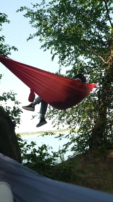 Pov man laying down in hammock with lake view Stock Footage 244114022