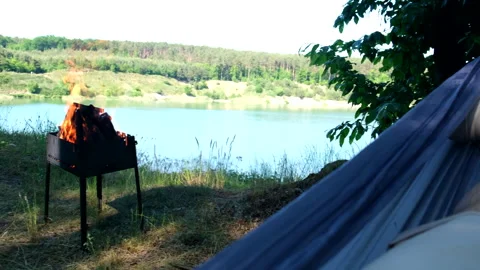 Pov man laying down in hammock with lake view Video stock 244800394