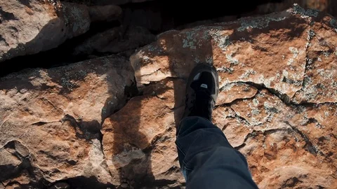 POV of Man Looking Down at Shoes on Rocky Ground Stock Footage 94308109