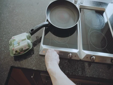 POV of a man preparing the frying pan for cooking breakfast Stock Footage 74664681