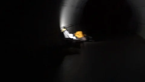 POV Man runs away from the chase at night in the tunnel Stock Footage