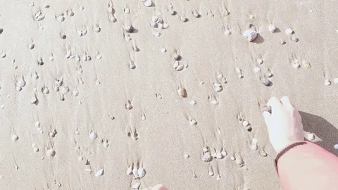 POV man on a sandy beach with seashells Video stock 82657703