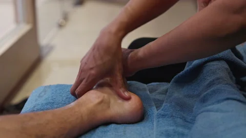POV Man sits relax, gets oil Thai foot massage by female spa masseuse therapist Stock-Footage 246664638