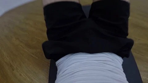 POV man trains abs by doing sit-ups on the ground at a gym Video stock 109752232