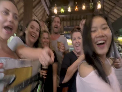 POV of a man walking into a bar pub with people greeting and kissing him Stock Footage 84893539