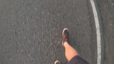 POV of a man walking on a paved road in Patagonia, Argentina during a sunset Stock Footage 130662983