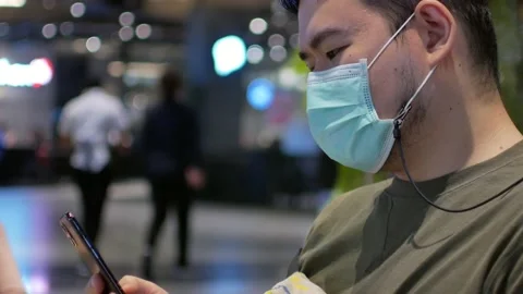 POV of a man wearing mask while using mobile phone Stock Footage 147263204