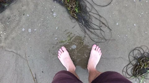 POV of a man's feet while he stand in the sea Stock Footage 138945971