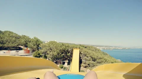 POV: Men slides down a very steep water slide at aquapark Stock Footage 65499642