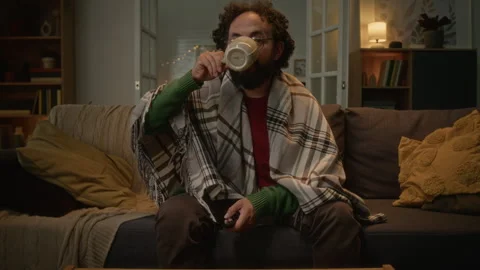 POV of Middle Aged Man Wrapped in Blanket Watching Tv Stock Footage 341673061