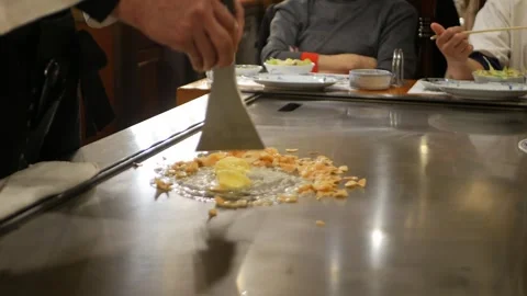 POV motion while chef is cooking fried garlic slided in teppanyaki pan in j.. 動画素材 313431837