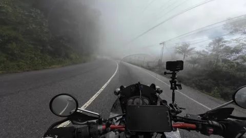 POV Motorcycle Riding Through Dense Fog into Pan-American Highway Mountain Town 스톡 동영상 333861667
