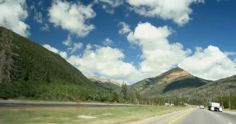 POV moving driving down rocky mountain highway clouds blue sky spring day I-70 Stock Footage 74026016