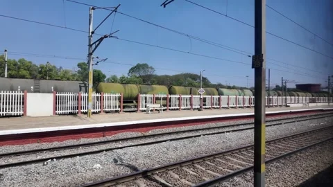 POV from moving train passing railway tracks and freight tanker wagons, tra.. Stock Footage 331936760