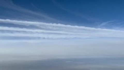 POV multiple white parallel contrails in a sunny blue sky, shot from a jet Stock Footage 278855445