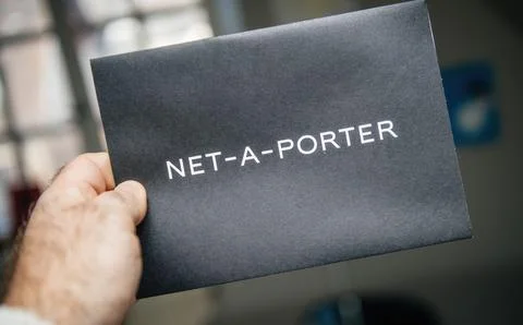POV Net A Porter envelope in hand Stock Photos