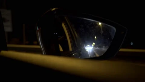 POV night shot of passenger's mirror of car, driving at highway 4K Stock Footage 136165760