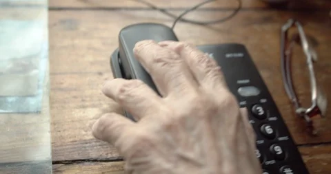 POV of an old hand picking up the phone and holding it to your ear. Stock Footage 130050272