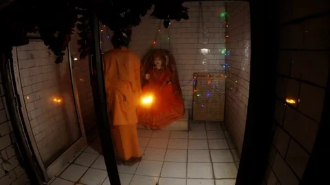 POV one looks on hindu monk performed night aarti in front of idol of Mata Parva Stock Footage 100299529
