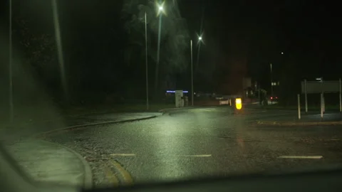 POV out of car window at night driving through suburban neighborhood Stock Footage 294997745