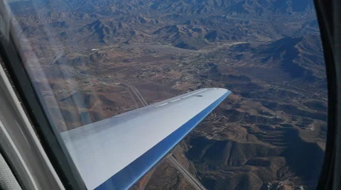 POV OUT LEAR JET WINDOW OVER DESERT Stock Footage 45203946