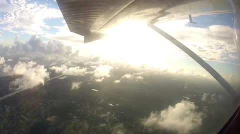 POV Out Of Plane Window At Sun w: Clouds Stock Footage 24676652