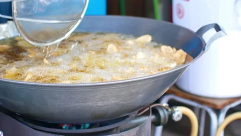 POV to the pan full of deep fried fresh banana for Thai snack Stock Footage 138163059