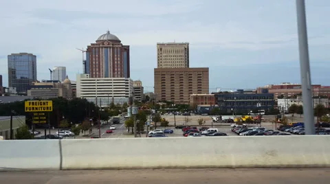 POV-passenger side window passing Houston, Texas skyline freeway traffic Video stock 57940205