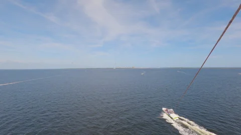 POV of person flying in air pulled from boat parasailing in Florida, sunny Stock-Footage 242392919
